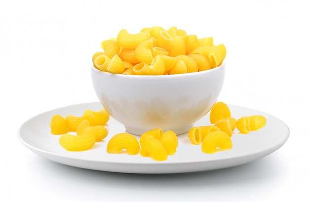 Dry macaroni in the white bowl on white space