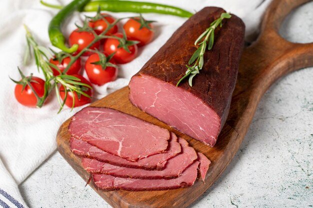 Dry meat Slices of dried and smoked dry meat on a wooden board Beef jerky pieces