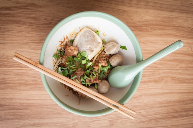 dry noolde meatball pork and tofu in the bowl and spoon