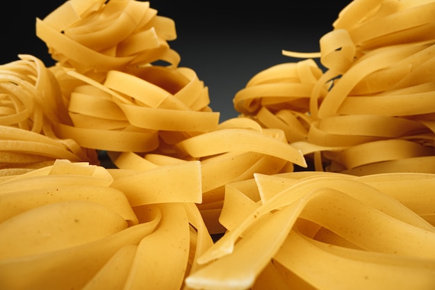Dry pasta on dark macro photo