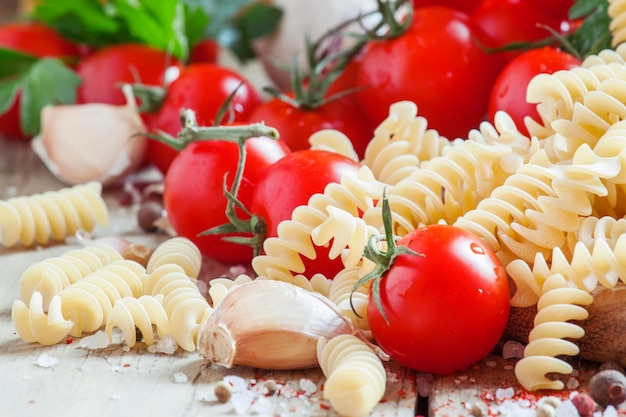 Dry pasta fusilli with tomatoes selective focus