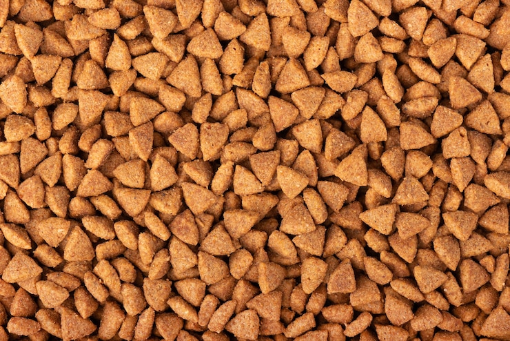 Photo dry pet food background. pile of granulated animal feeds