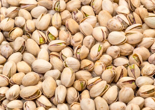 Dry pistachios as food background Top view