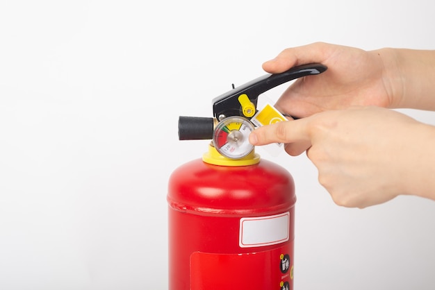 Dry powder fire extinguisher on white background