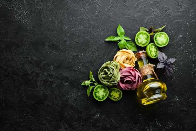 Dry purple pasta with tomatoes and parsley oil Italian traditional cuisine Fresh vegetables Top view Free space for your text