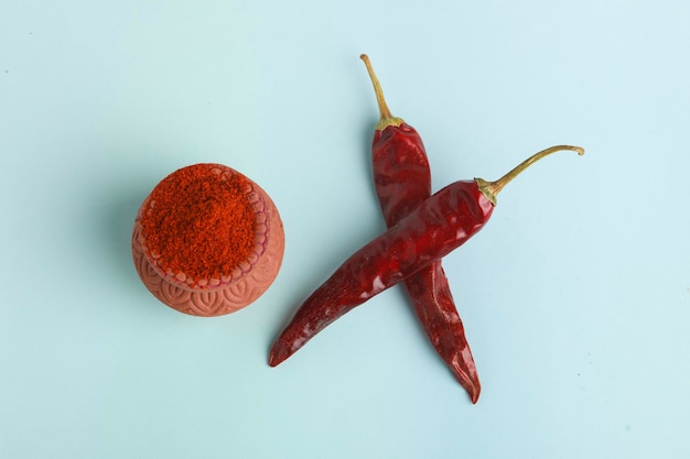 Dry red chilly and powder on white background.