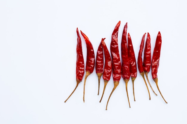 Dry red hot chili peppers on white background