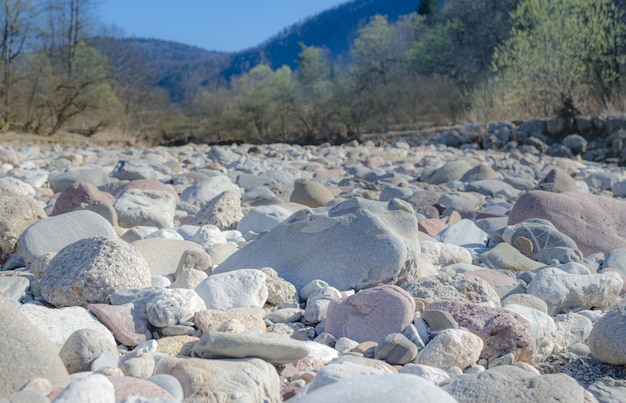 Dry riverbed full of pebble stones scorched by sun