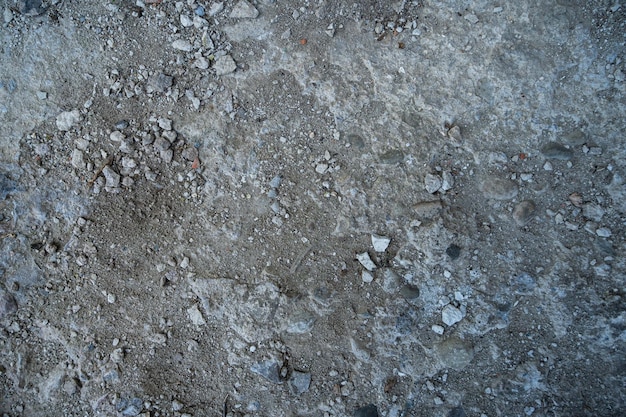 Dry road with dirt sand and small stones pebbles