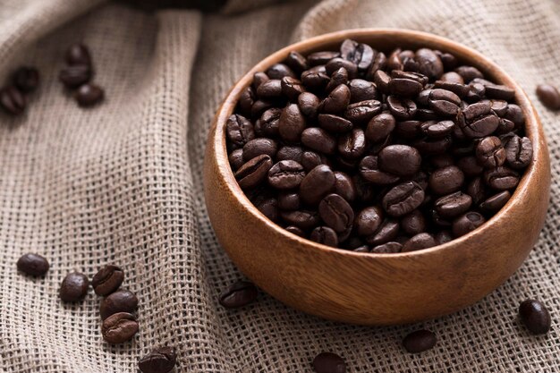 Dry roasted coffee beans in wooden bowl