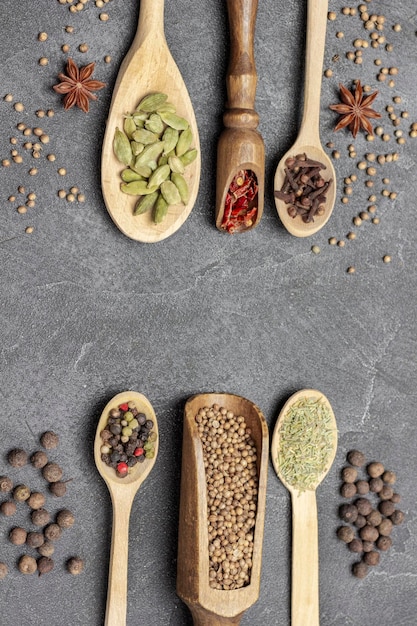 Dry spices in wooden spoons and scoops