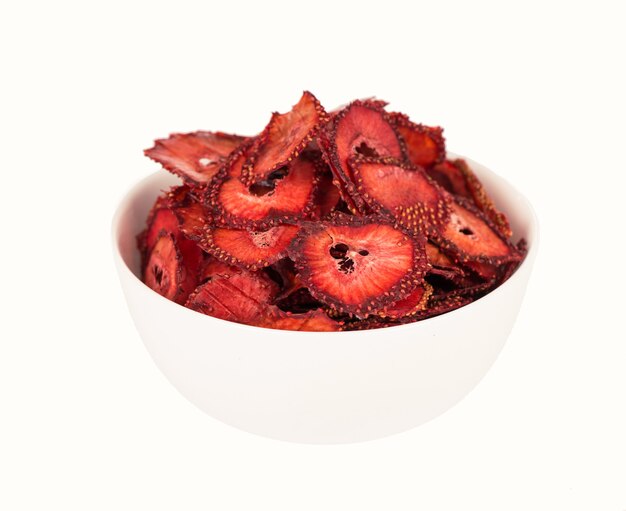 Dry strawberry in a white plate, strawberry fruit chips isolated on white background