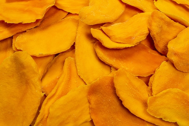 Photo dry tasty mango slices isolated on a white background. top view.