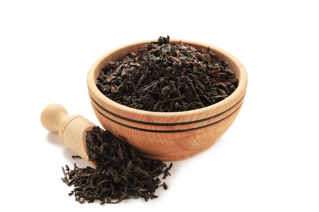 Dry tea leaves in bowl isolated on white background