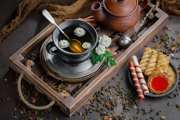 Dry tea leaves on a table on an old background