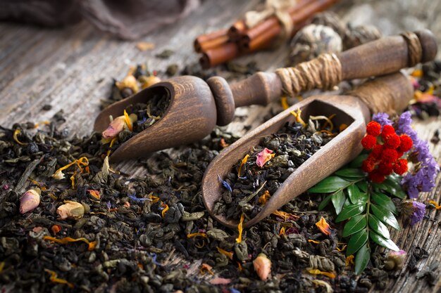 Dry tea leaves on a table on an old background