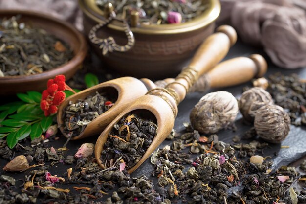 Dry tea leaves on a table on an old background.