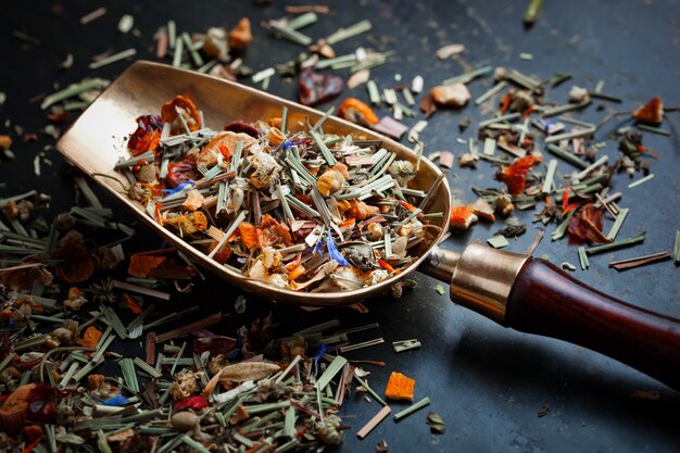 Dry tea leaves on a table on an old background