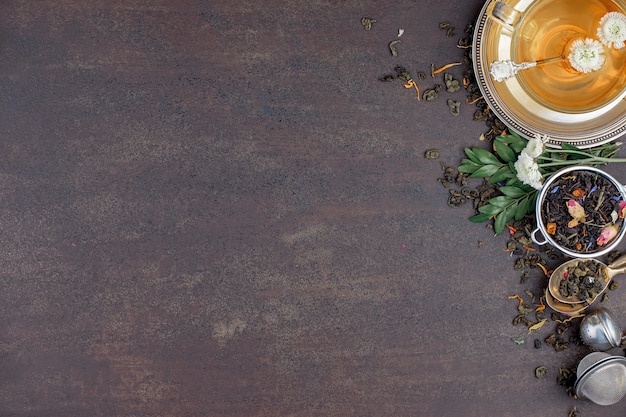 Dry tea leaves on a table on an old background