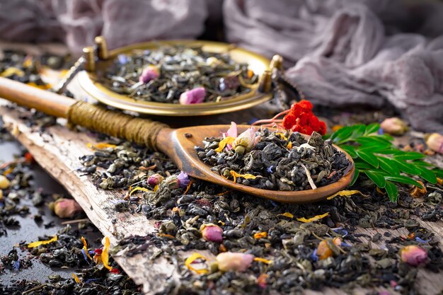 Dry tea leaves on a table on an old background