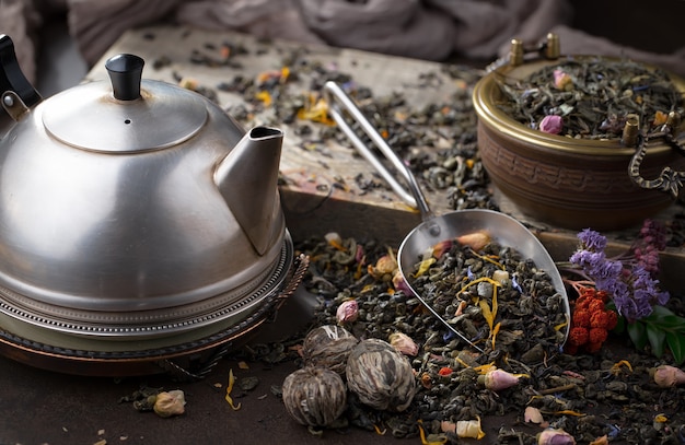 Dry tea leaves on a table on an old background