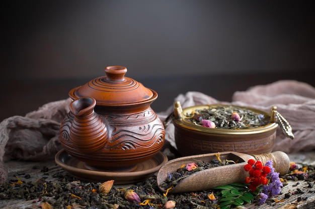 Dry tea leaves on a table on an old background