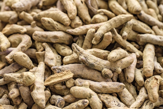 Dry turmeric roots in bulk at the oriental bazaar selective focus