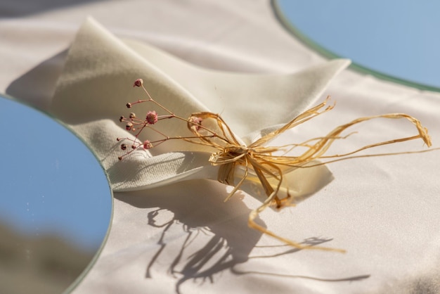 Dry weed with flower on white cloth photo