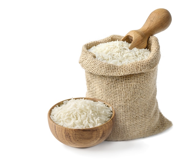 Photo dry white long rice basmati in wooden bowl and burlap sack with wooden scoop isolated on white background.