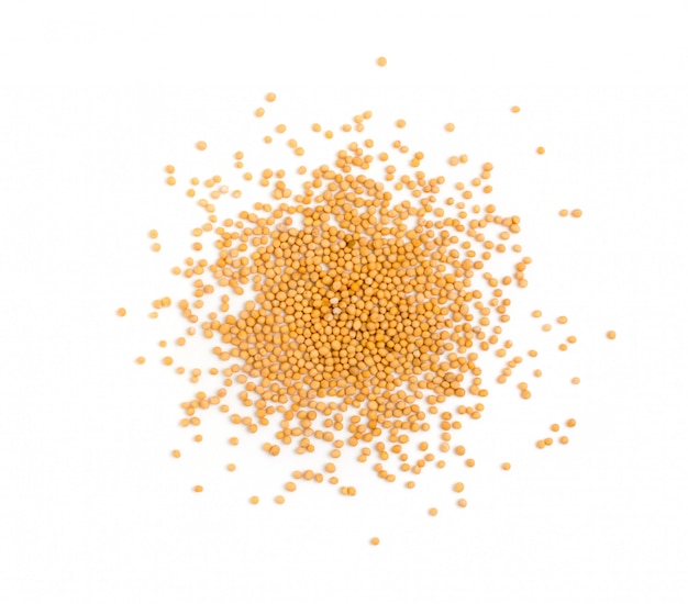 Dry yellow mustard seeds isolated on white background top view.