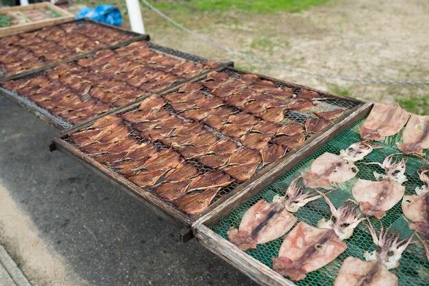 Drying squid and fish in market