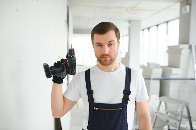 drywall worker works on building site in a house