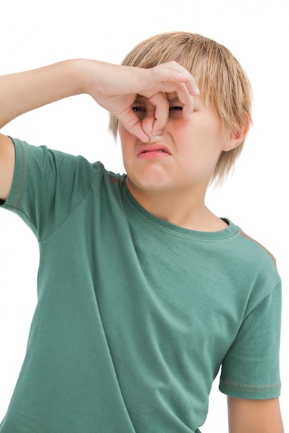 Photo dsigusted boy pinching his nose