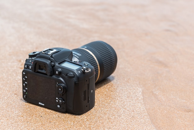 DSLR camera on beach wet from water sea wave