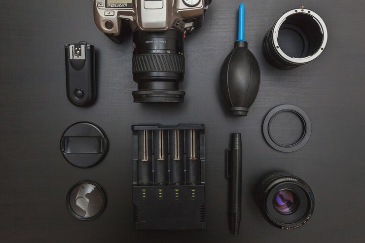 फोटो dslr camera system, camera cleaning kit, lens and camera accessory on black