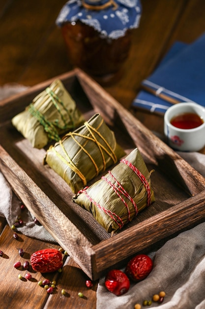 Duanwu festival rice dumplings and rice wine on wooden plate