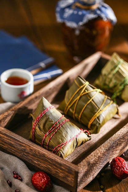 Duanwu festival rice dumplings and rice wine on wooden plate