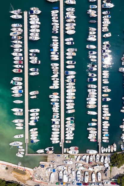 Dubrovnik marina with boats at Mediterranean sea vacation Dalmatia aerial photo view from above portrait format traveling in Croatia