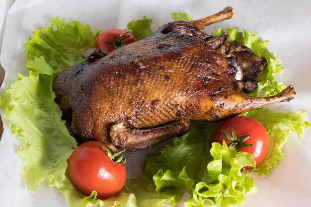 Duck baked until golden brown lies on a light background