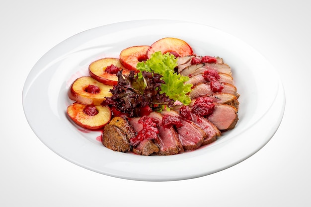 Duck breast mangre with berry confit and baked apple On a white background