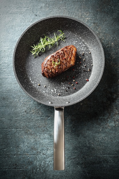 Duck breast roasted in ceramic pan with salt spices and rosemary.