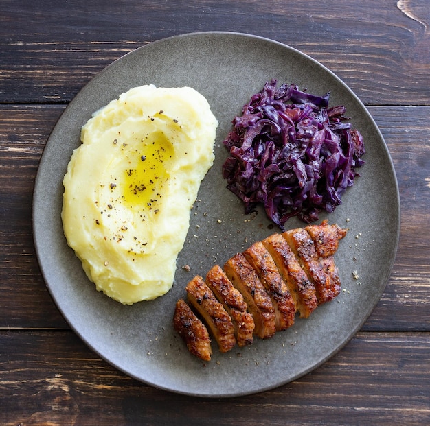 Duck breast with mashed potatoes and red cabbage