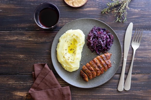 Duck breast with mashed potatoes and red cabbage