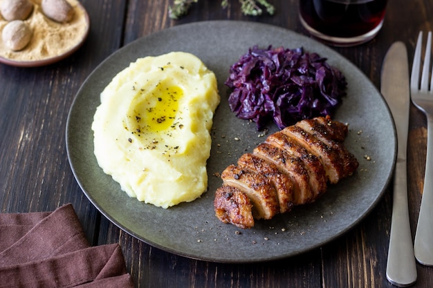 Duck breast with mashed potatoes and red cabbage