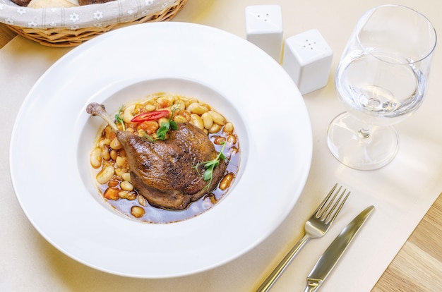 Duck confit leg with white bean garnish