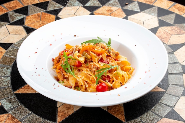 Duck fettuccine with cherry tomatoes in red sauce