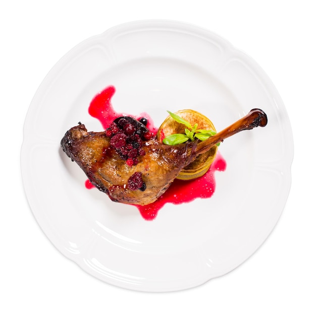 Photo duck leg confit with red berry sauce