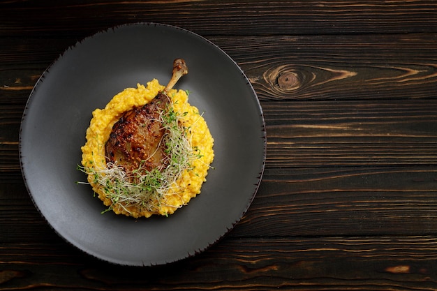 Duck leg with risotto pumpkin and herbs