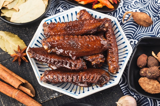 The duck's wings were boiled and placed on a  plate