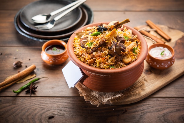 Photo dum handi muttonãâãâ biryaniãâãâ or gosht pilaf is prepared in an earthen or clay pot called haandi or 1 kilo size. popular indian non vegetarian foodãâãâ 